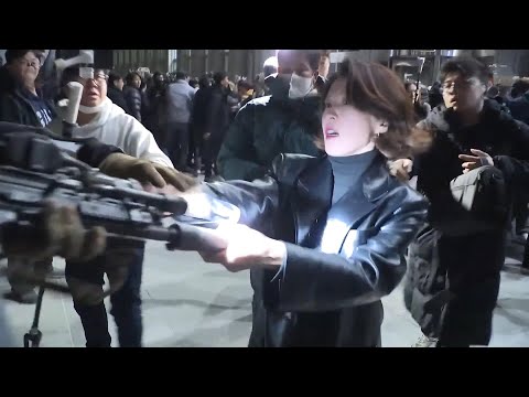 defiant woman grabs south korean soldiers gun during protests against martial law